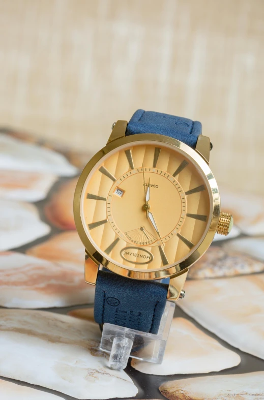 a close up of a watch on a table, inspired by Barthélemy Menn, blue and gold color scheme, burberry, grain”, thumbnail