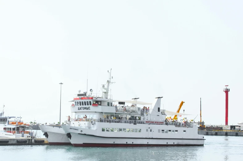 a large white boat sitting on top of a body of water, hurufiyya, on the sea, commercially ready, exterior shot