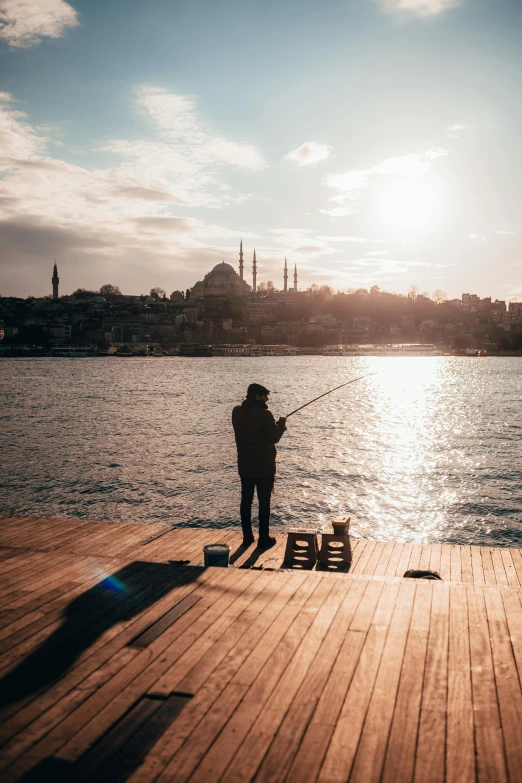 a person standing on a dock with a fishing rod, pexels contest winner, hurufiyya, fallout style istanbul, beautiful late afternoon, sittin