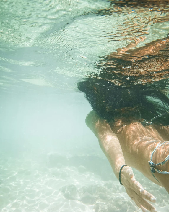 a woman in a bikini swims under water, by Hannah Tompkins, unsplash contest winner, slightly tanned, tourist photo, instagram story, manly