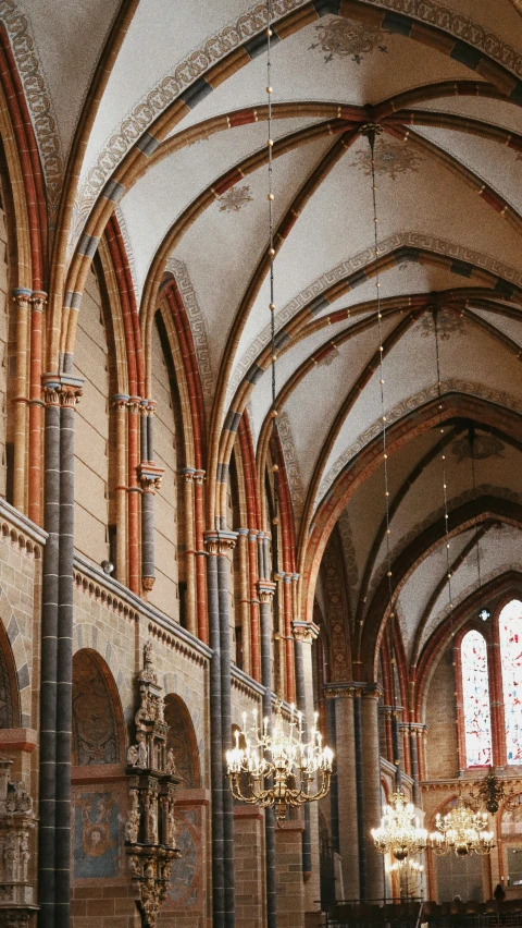 the inside of a church with a chandelier hanging from the ceiling, by Jan Tengnagel, pexels, romanesque, dry archways and spires, helmond, red brown and grey color scheme, thumbnail