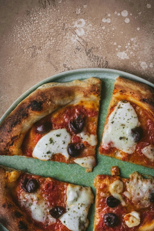 a pizza sitting on top of a green plate, inspired by Géza Dósa, trending on unsplash, renaissance, smooth matte, woodfired, medium shot angle, detailed product image