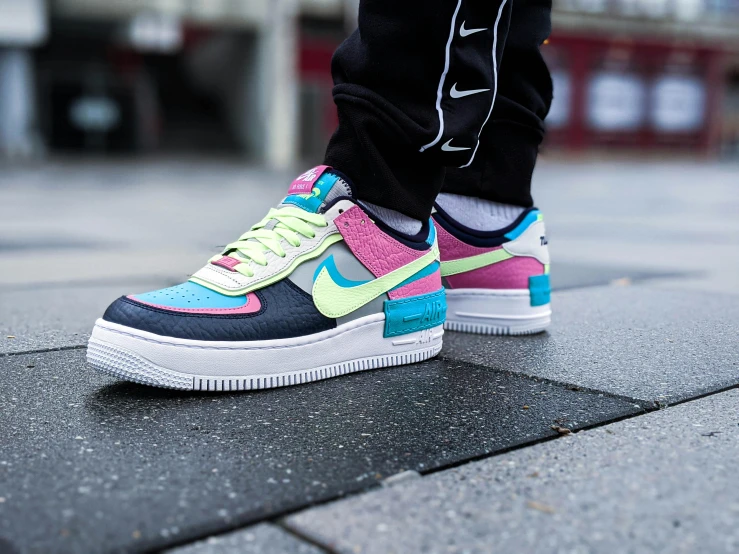 a close up of a person's shoes on a sidewalk, a cartoon, by Niko Henrichon, unsplash, turquoise pink and green, air force, wearing