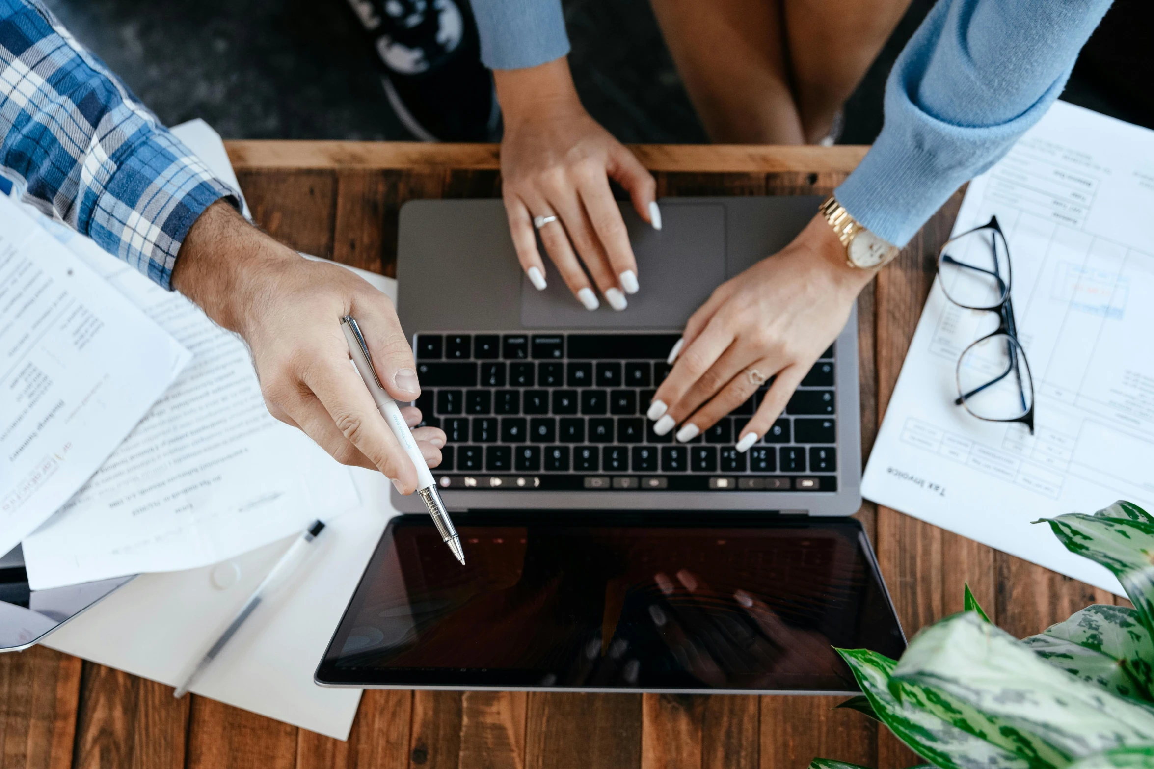 a couple of people sitting at a table with a laptop, pexels contest winner, professional branding, background image, bottom angle, working