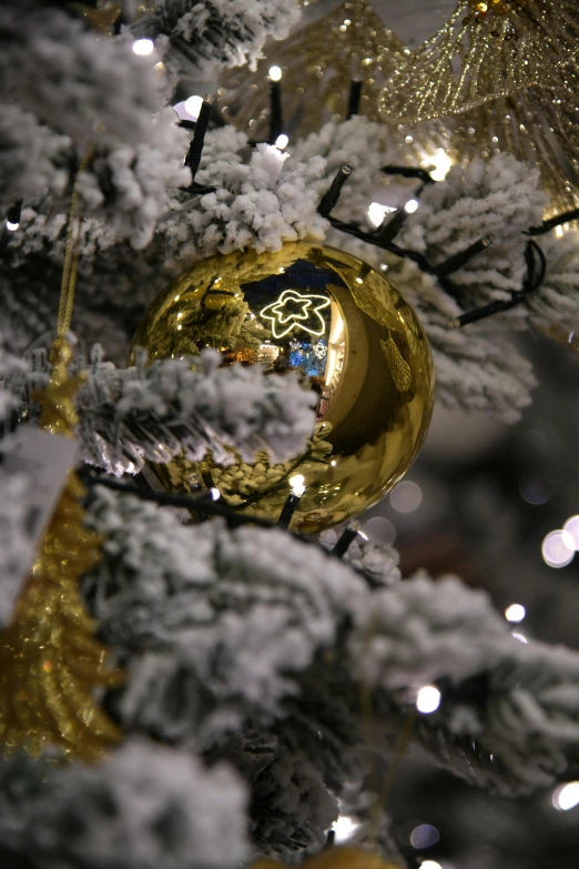 a close up of a christmas tree with gold ornaments, by Dan Content, happening, gold foil, grey, globes, stars