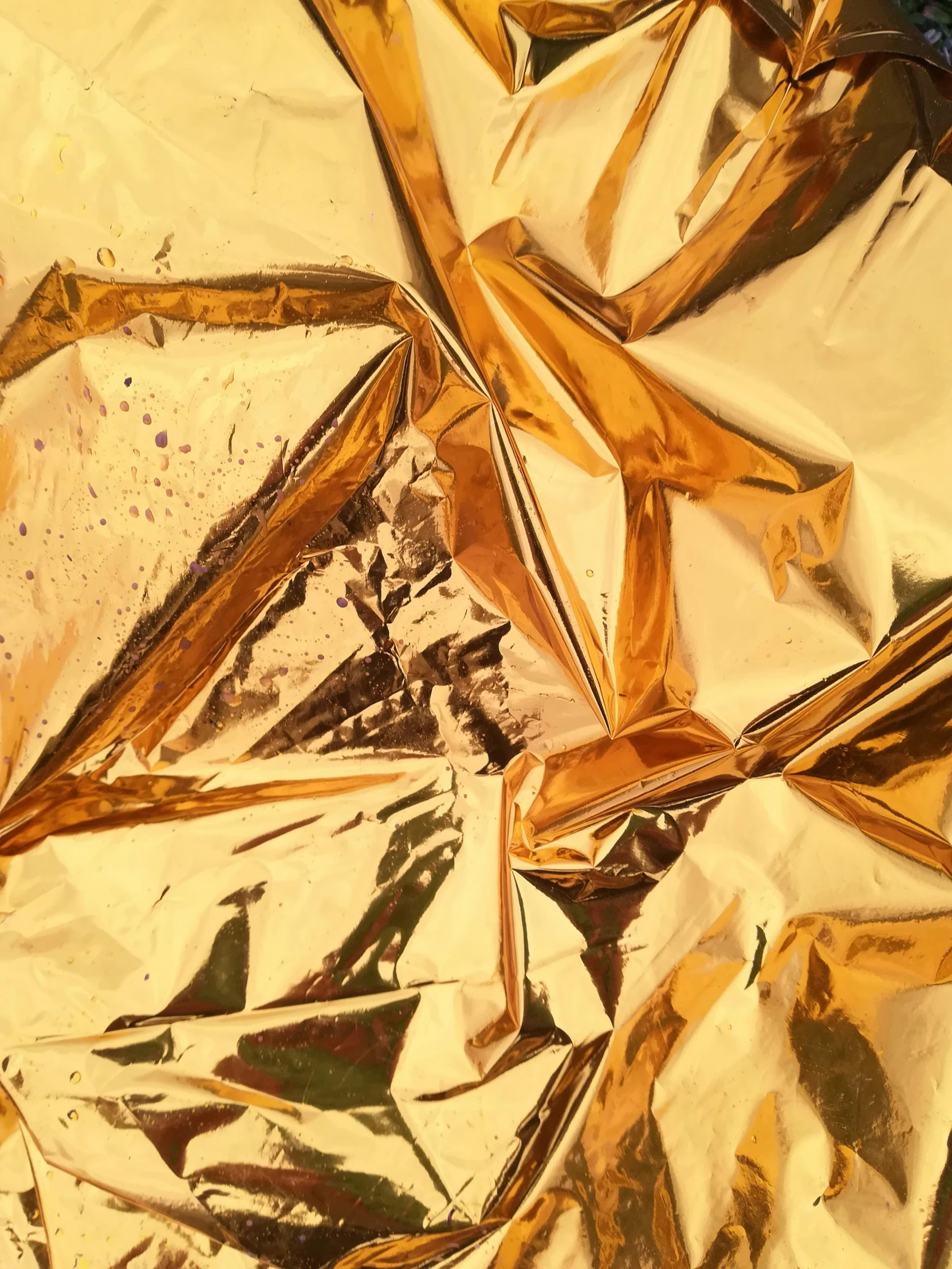 a piece of foil sitting on top of a table, a detailed painting, trending on unsplash, panfuturism, draped in gold, triangle shards, detailed photo of an album cover, ( ( extreme detail ) )