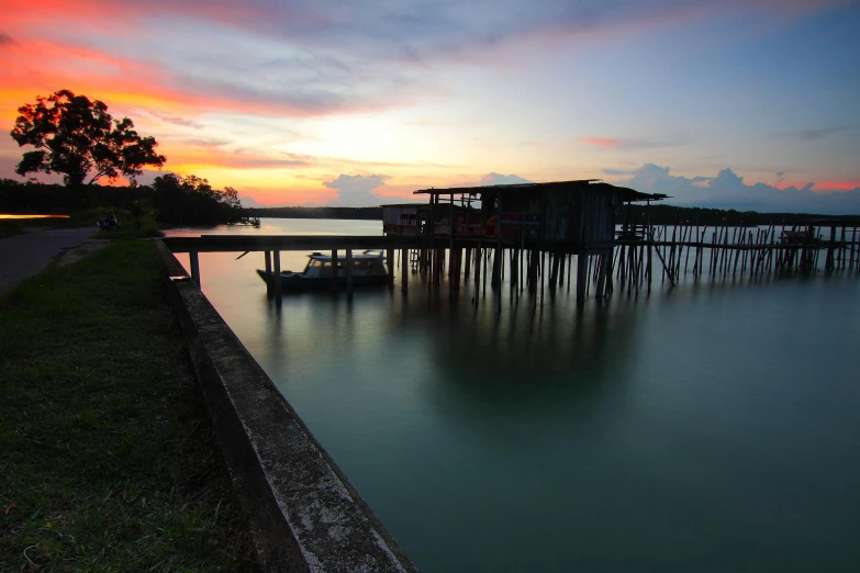 a boat that is sitting in the water, by Erik Pevernagie, pexels contest winner, hurufiyya, near a jetty, malaysian, crepuscule, leaking