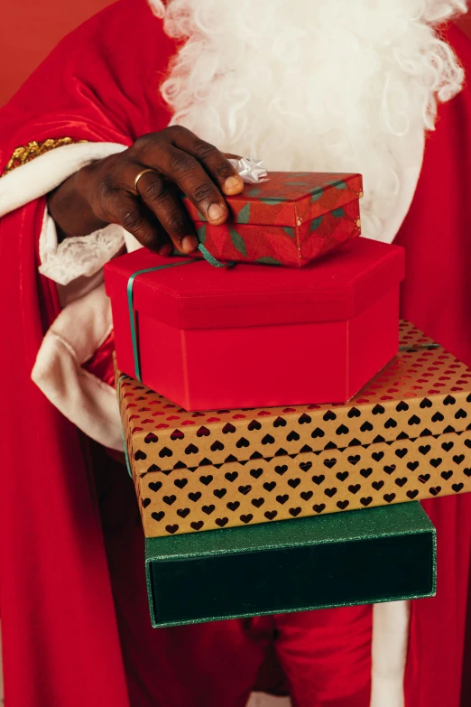 a man dressed as santa claus holding a stack of presents, an album cover, inspired by Geertgen tot Sint Jans, pexels, renaissance, black man, low detail, royal robe, giving gifts to people