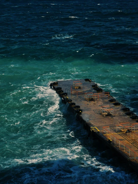 a large ship in the middle of the ocean, an album cover, inspired by Elsa Bleda, pexels contest winner, hurufiyya, oil spills, small dock, looking this way, high quality product image”