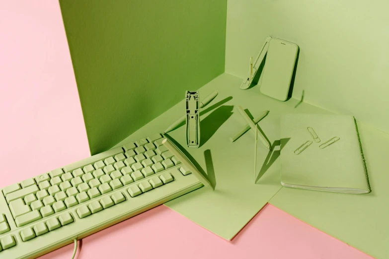 a computer keyboard sitting on top of a green desk, inspired by Art Green, holly herndon origami statue, pastel pink neon, exploded view, olive green