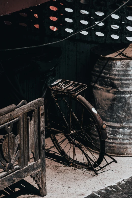 a bicycle parked on the side of a street, a still life, pexels contest winner, assemblage, 9 steel barrels in a graveyard, an antique, brown, wabi sabi