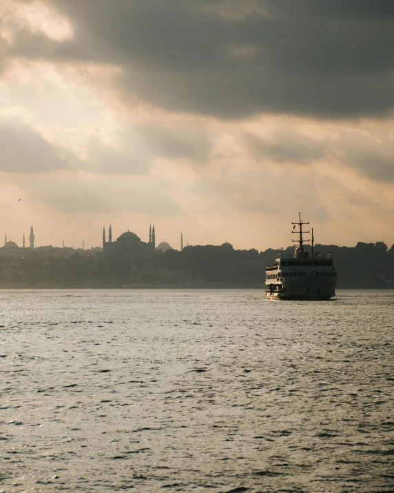 a boat floating on top of a large body of water, by Ismail Acar, pexels contest winner, hurufiyya, istanbul, lgbtq, historical footage, 🚿🗝📝