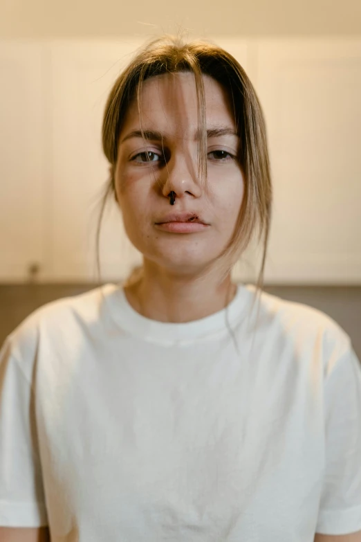 a woman in a white shirt standing in a kitchen, a character portrait, trending on unsplash, hyperrealism, bruised face, detailed face ), wearing a t-shirt, indoor picture