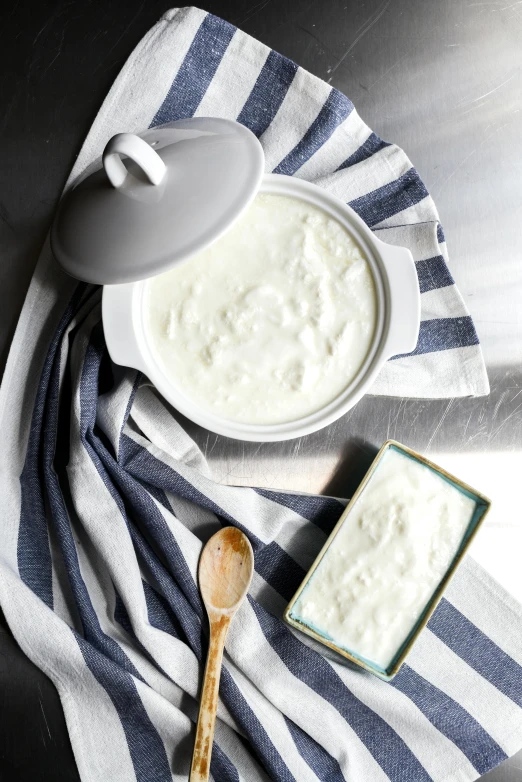 a bowl of yogurt sitting on top of a blue and white towel, vessels, square, product image, ivory rococo