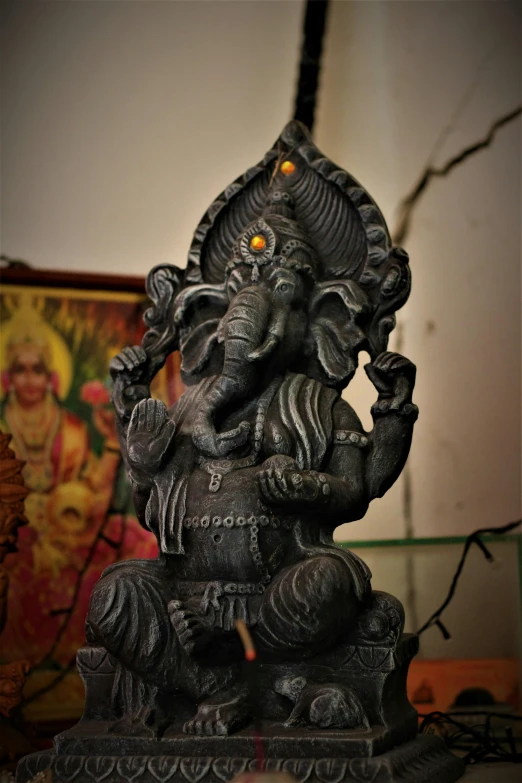 a statue of an elephant sitting on top of a table, evil god, hindu aesthetic, made of tar, trippy