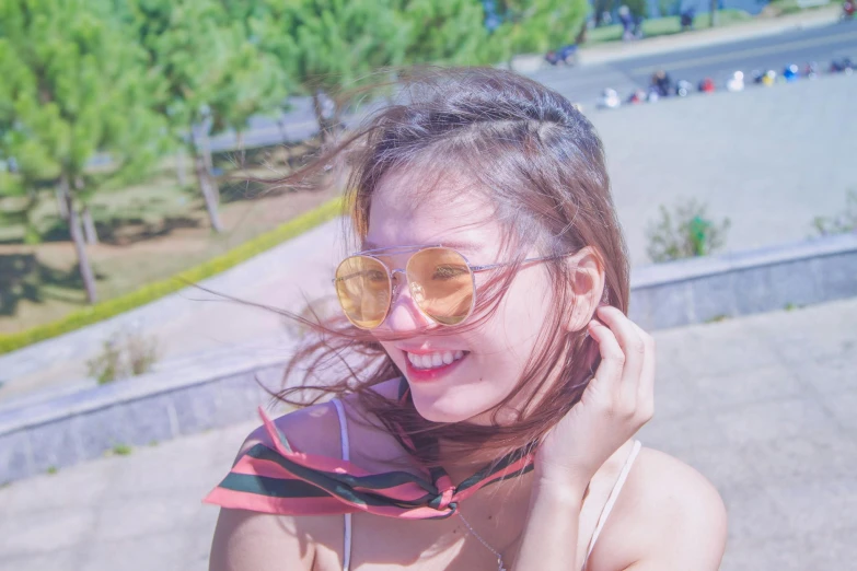 a woman with her hair blowing in the wind, pexels contest winner, sun glasses, ulzzang, goofy smile, instagram story
