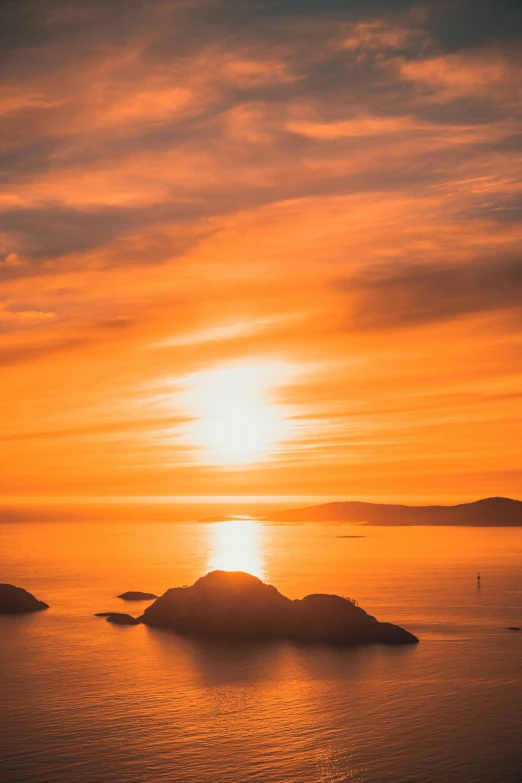 the sun is setting over a body of water, pexels contest winner, romanticism, islands on horizon, wellington, vibrant orange, today\'s featured photograph 4k