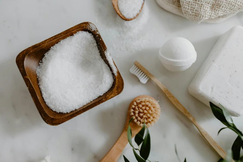 a wooden bowl sitting on top of a marble counter, a still life, trending on pexels, brushes her teeth, covered in salt, eco, background image