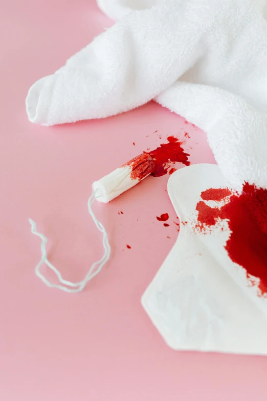 a white towel sitting on top of a table covered in blood, by Julia Pishtar, trending on pexels, gum tissue, floggers, pink and red color scheme, ilustration