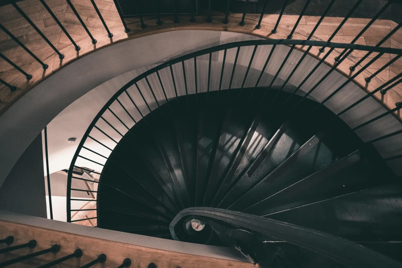 a black and white photo of a spiral staircase, inspired by Elsa Bleda, pexels contest winner, ashford black marble, bespoke, deep colour, high view