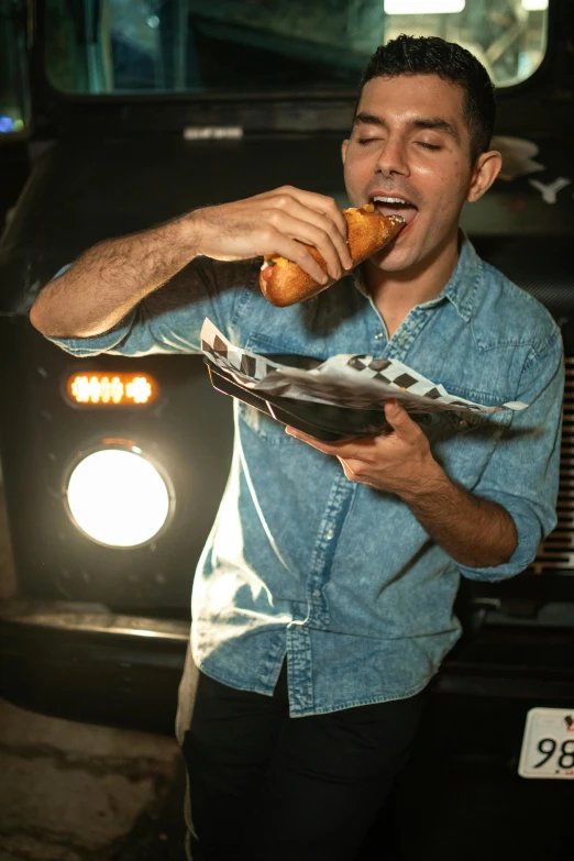 a man eating a hot dog in front of a truck, pexels contest winner, zachary quinto, on black background, pizza, cone