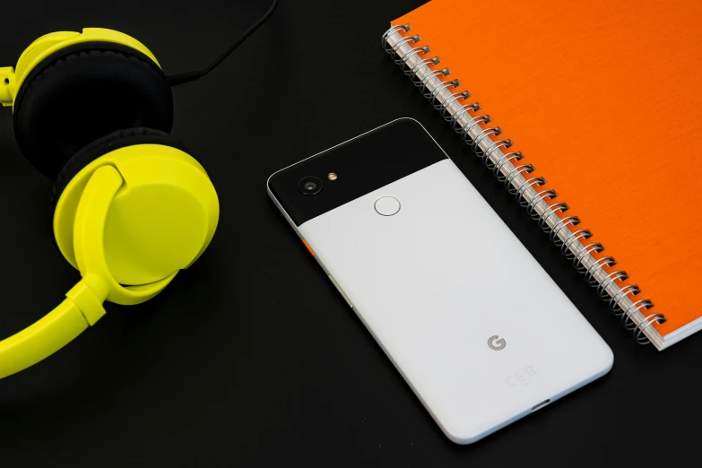 a cell phone, headphones, and notebook on a table, by Android Jones, google parti quality, white and orange, pixel, portrait n - 9