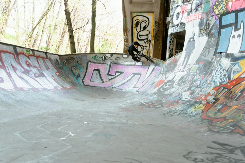 a man riding a skateboard up the side of a ramp, a picture, graffiti, muspelheim, bowl, hidden area, curves!!
