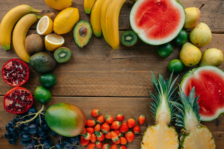 a variety of fruits arranged in a circle on a wooden surface, trending on unsplash, background image, avatar image