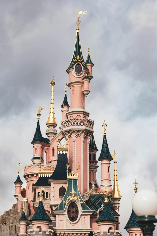 a pink castle sitting on top of a lush green field, inspired by disney, trending on unsplash, art nouveau, mickey mouse ears, tall metal towers, french village exterior, photo for a store