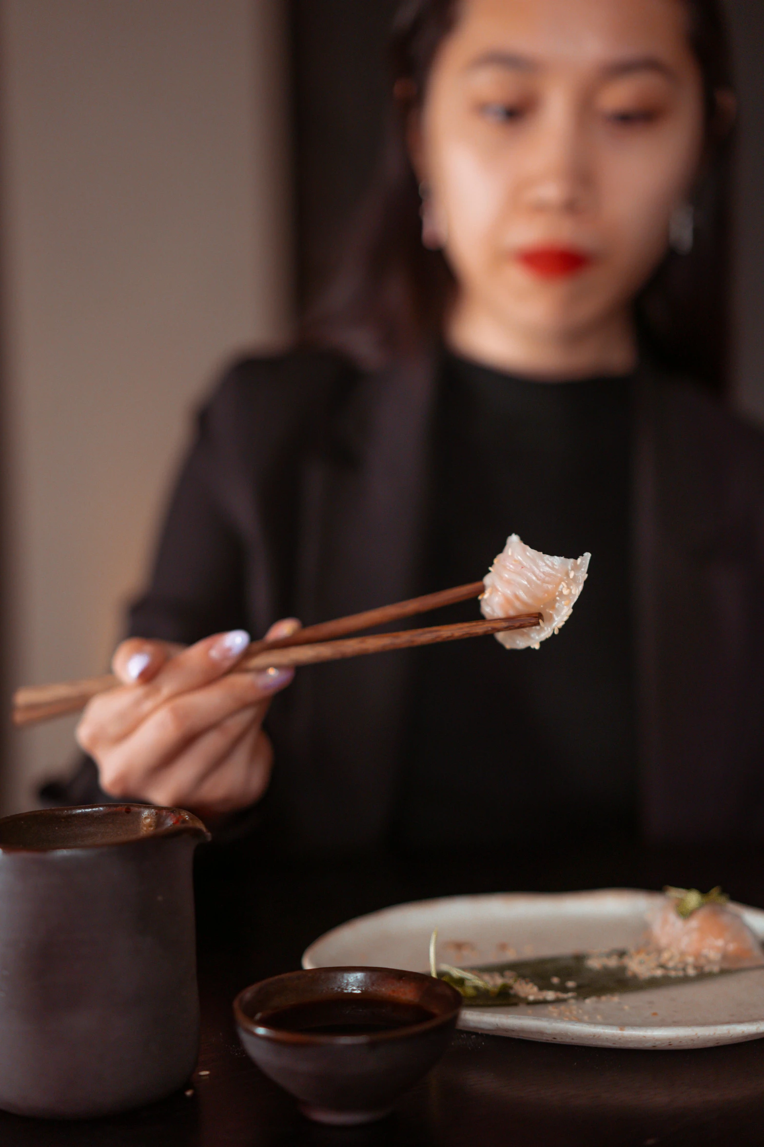 a woman holding chopsticks over a plate of food, translucent gills, gentle lighting, kintsugi, japanese collection product