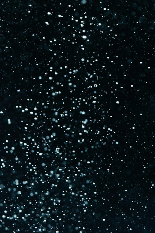 a man riding a snowboard down a snow covered slope, an album cover, by Howardena Pindell, space art, black night sky, [ bubbles, glitter gif, boke