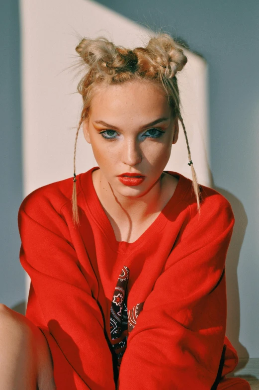 a woman in a red dress sitting on a bed, inspired by Louisa Matthíasdóttir, trending on pexels, renaissance, she is wearing streetwear, pigtail, pout, close up of a blonde woman