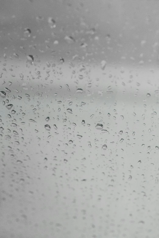 a black and white photo of rain on a window, an album cover, unsplash, humidity mold, video, background image, hazy