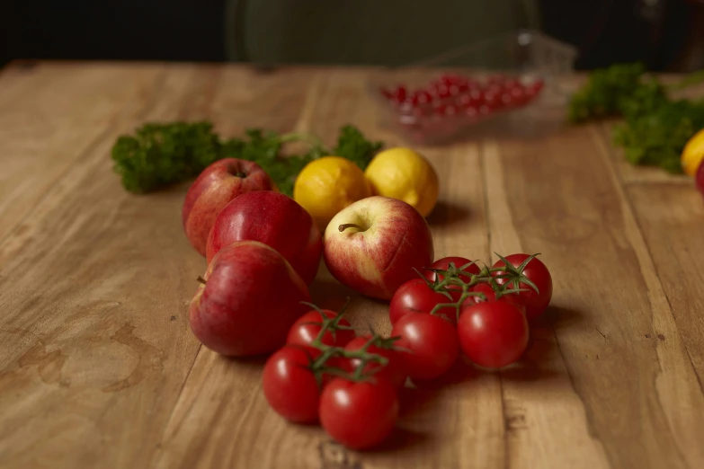 a wooden table topped with lots of fruit and vegetables, medium angle, red apple, product shot, pomegranate