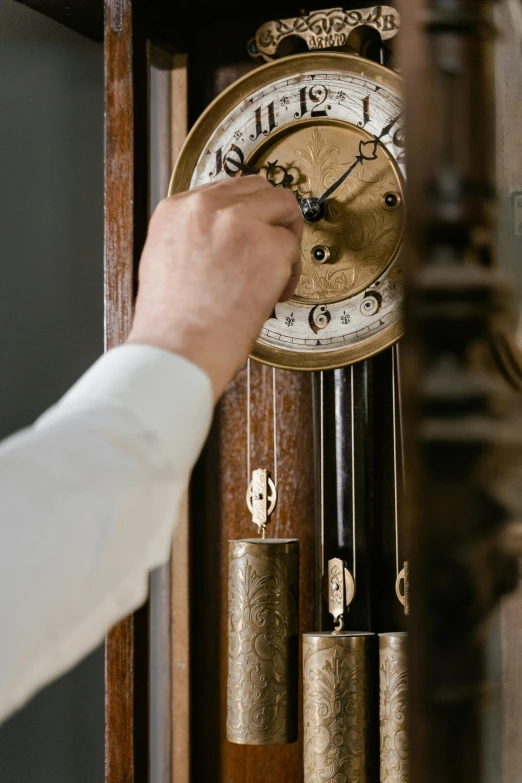 a close up of a person holding a clock, arts and crafts movement, white mechanical details, brown, thumbnail, knobs