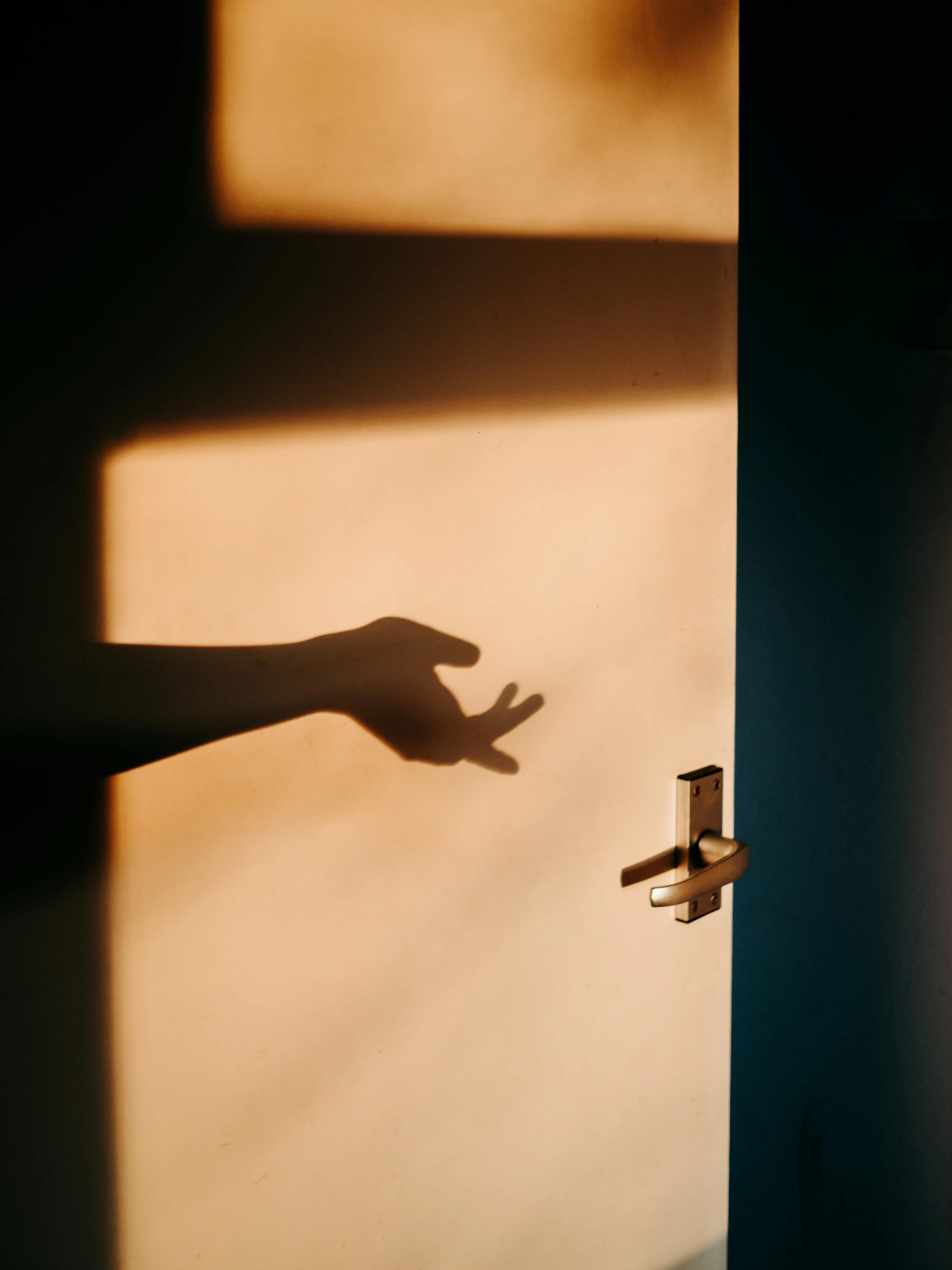 a person's hand reaching out of a door, by Maciej Kuciara, pexels contest winner, conceptual art, gold hour light, ignant, high shadow, instagram post