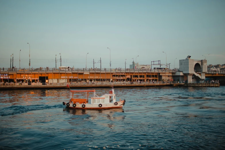 a boat in a body of water near a bridge, by Elsa Bleda, pexels contest winner, hurufiyya, shipping docks, azamat khairov, youtube thumbnail, brown