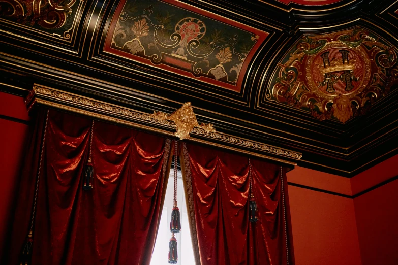 a room with a chandelier and red curtains, cinémascope, ornate with gold trimmings, thumbnail, it has a red and black paint