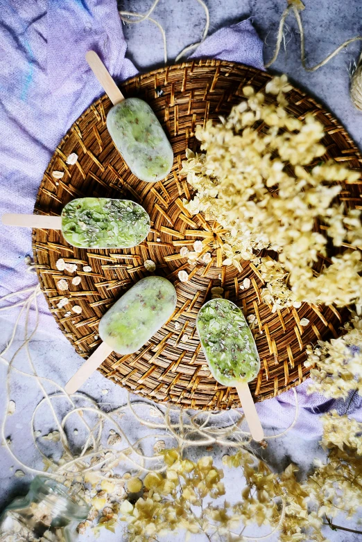 a close up of a plate of food on a table, green and warm theme, lollipops, granite, freezing