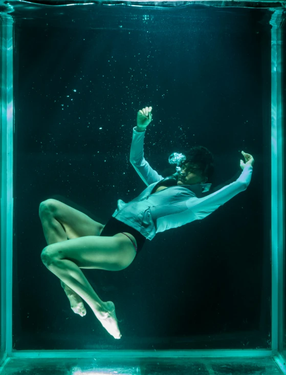 a woman is floating in a glass box, a hologram, inspired by David LaChapelle, unsplash contest winner, olympic diving springoard, promo image, deep water, ashteroth