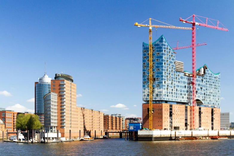 a large body of water surrounded by tall buildings, inspired by Victor Enrich, pexels contest winner, hypermodernism, cranes, berlin, bright construction materials, docks