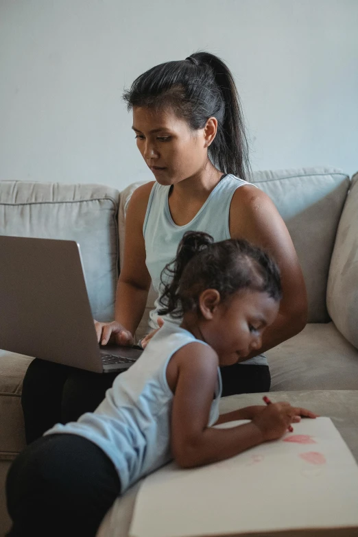 a woman and a child sitting on a couch with a laptop, by artist, pexels contest winner, happening, malaysian, serious business, summer morning, scribbled