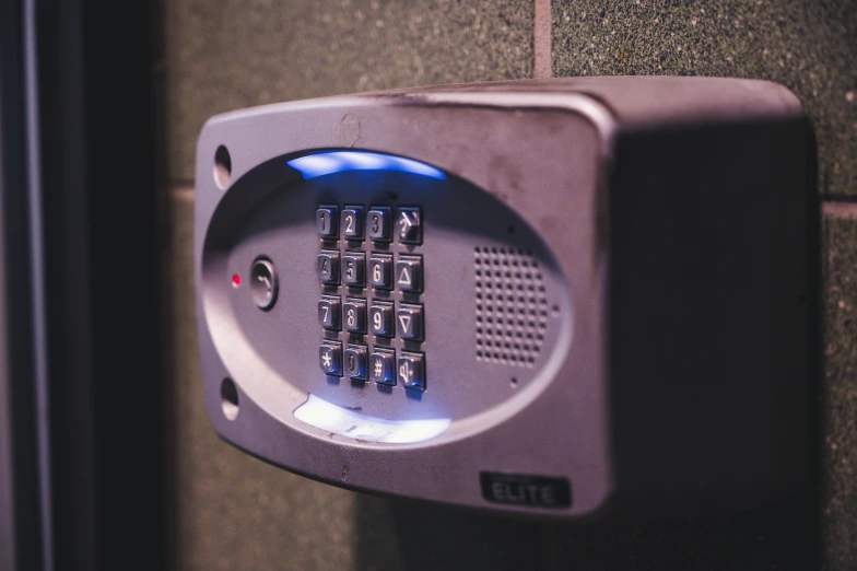 a close up of a keypad on a wall, a digital rendering, inspired by Elsa Bleda, pexels, police box, location in a apartment, led, grey