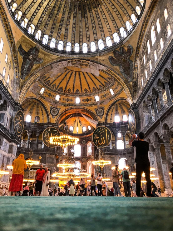 a group of people standing inside of a building, a mosaic, black domes and spires, istanbul, inside a grand, and