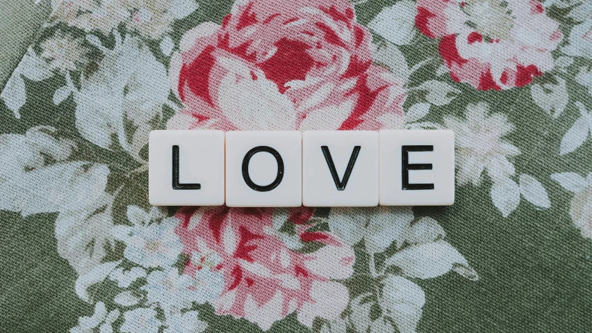 a scrabble with the word love spelled on it, a cross stitch, by Emma Andijewska, pixabay, graffiti, floral, avatar image, vintage photo, chiffon