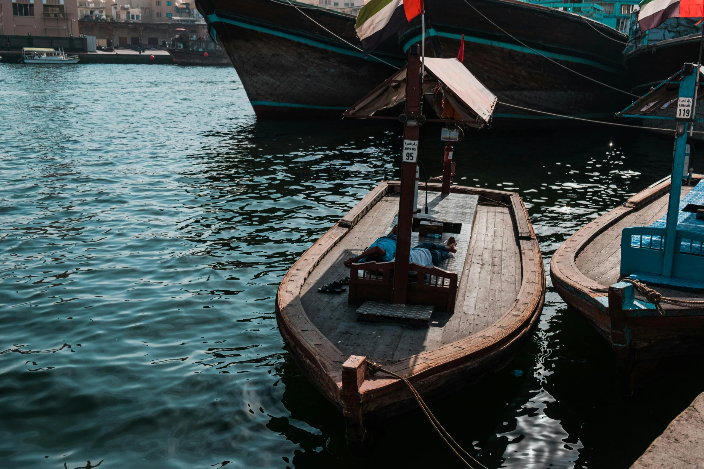 a couple of boats that are sitting in the water, by Julia Pishtar, pexels contest winner, hurufiyya, middle eastern style vendors, thumbnail, carson ellis, dingy