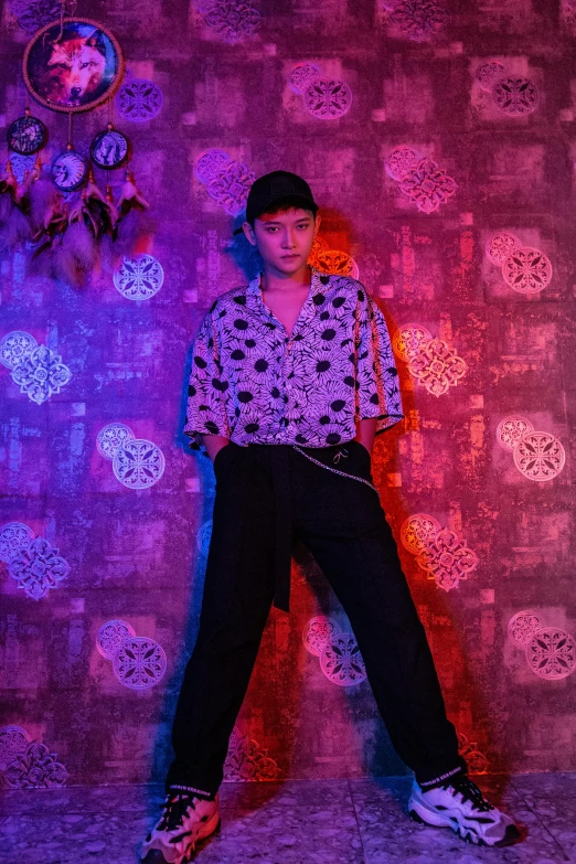 a woman standing in front of a colorful wall, an album cover, inspired by Chen Chi, purple and black clothes, with hawaiian shirt, standing in a dimly lit room, zezhou chen