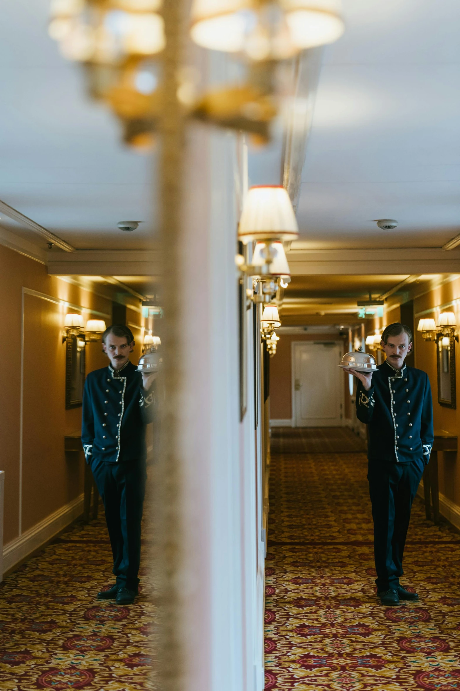 a man taking a picture of himself in a mirror, an album cover, by Nina Hamnett, unsplash, the shinning hotel hallway, full dress uniform, wedding, royal interior