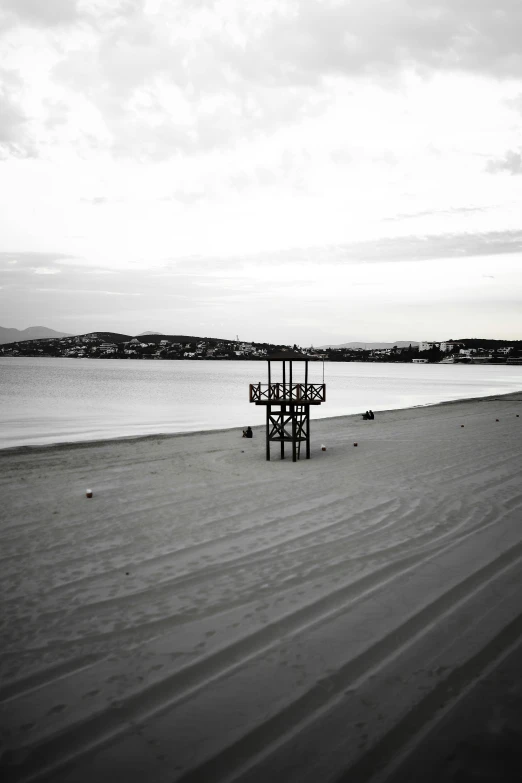 a black and white photo of a lifeguard stand on a beach, a black and white photo, unsplash, conceptual art, photo of zurich, ffffound, medium format, cityscape