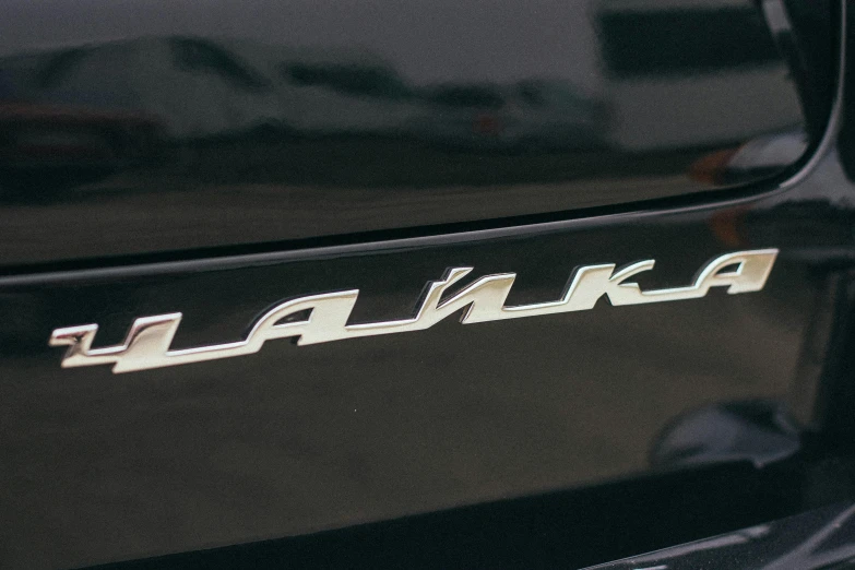 a close up of a car with a logo on it, ranker, fleks, detailed shot, light and dark